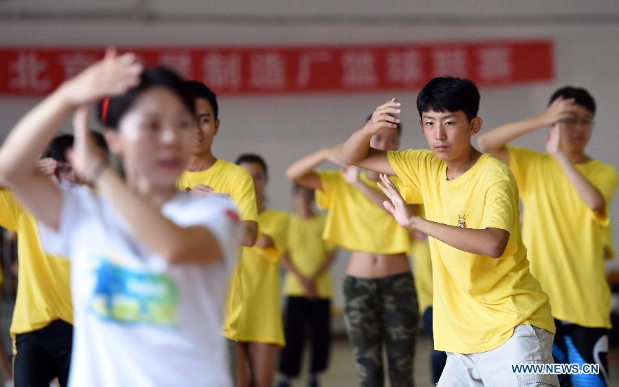 Overseas Chinese youth learn to perform Tai Chi during the 'Chinese Root-Seeking Tour' Summer Camp in Beijing, capital of China, Aug. 7, 2015.