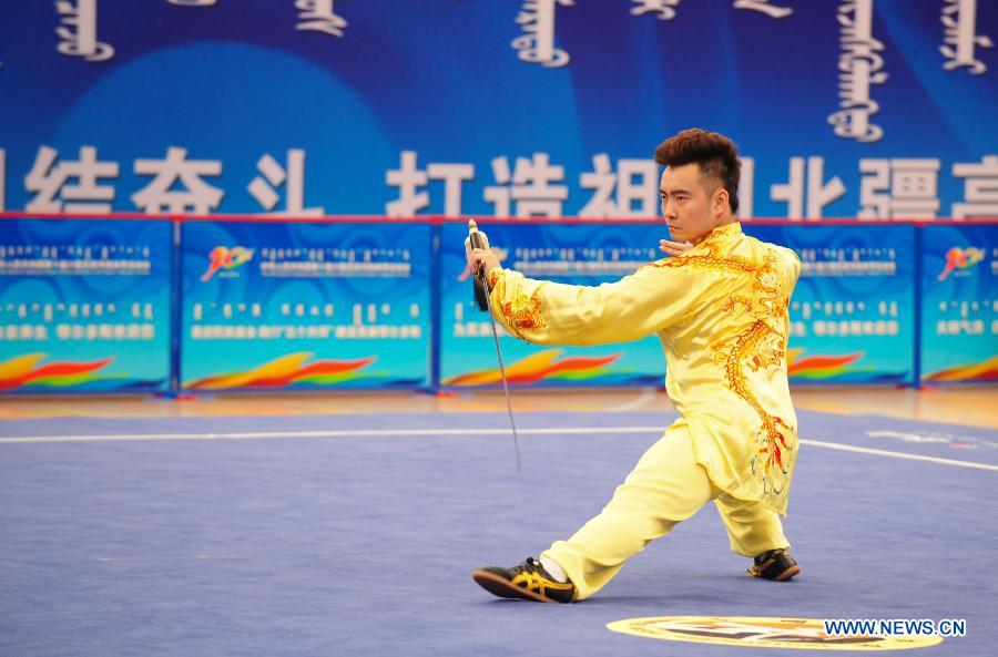 Zhang Zhenxing from central China's Henan Province competes in a men's game of martial arts of the ethnic minorities during the 10th National Traditional Games of Ethnic Minorities of China in Ordos, north China's Inner Mongolia Autonomous Region, Aug. 10, 2015. 