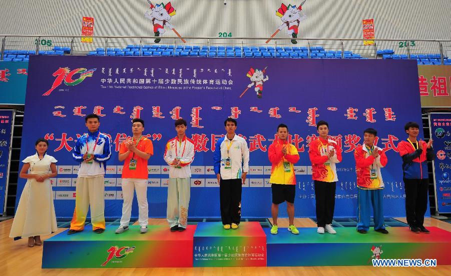 Prize-winners of a men's game of martial arts among the ethnic minorities attend an awarding ceremony during the 10th National Traditional Games of Ethnic Minorities of China in Ordos, north China's Inner Mongolia Autonomous Region, Aug. 10, 2015. 