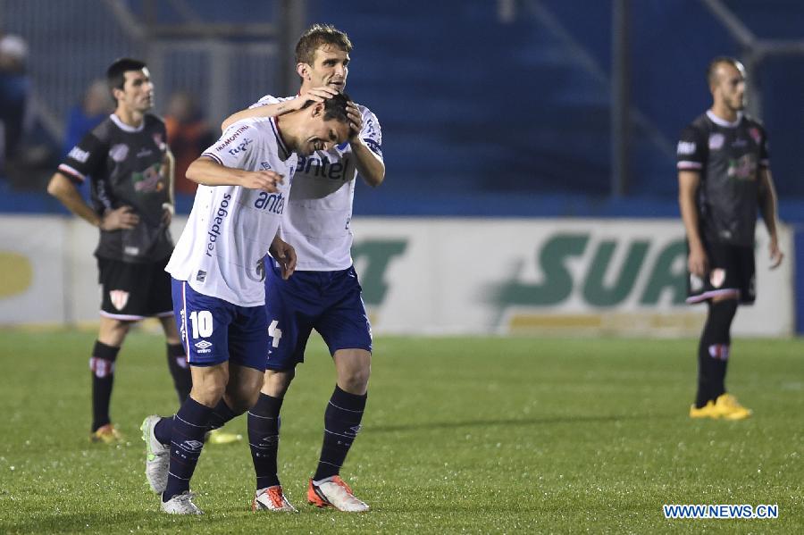 Nacional's Ignacio Gonzalez (FRONT) celebrates scoring with his teammate Ivan Alonso (BACK), during their match on day 1 of the Opening Tournament of the Uruguyan Soccer Championship, against Villa Teresa, held in the Gran Parque Central stadium, in Montevideo, capital of Uruguay, on Aug. 15, 2015. 