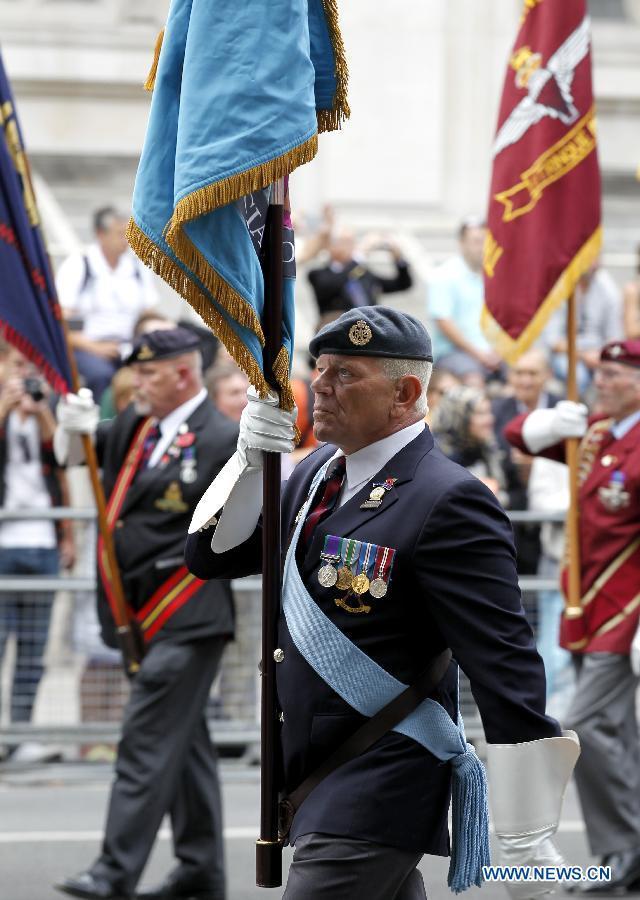 Veterans are seen in a parade from Horse Guards Parade to Westminster Abbey after a service of commemoration during the 70th Anniversary commemorations of VJ Day (Victory over Japan) in London, Britain, on Aug. 15, 2015. (Xinhua/Han Yan) 