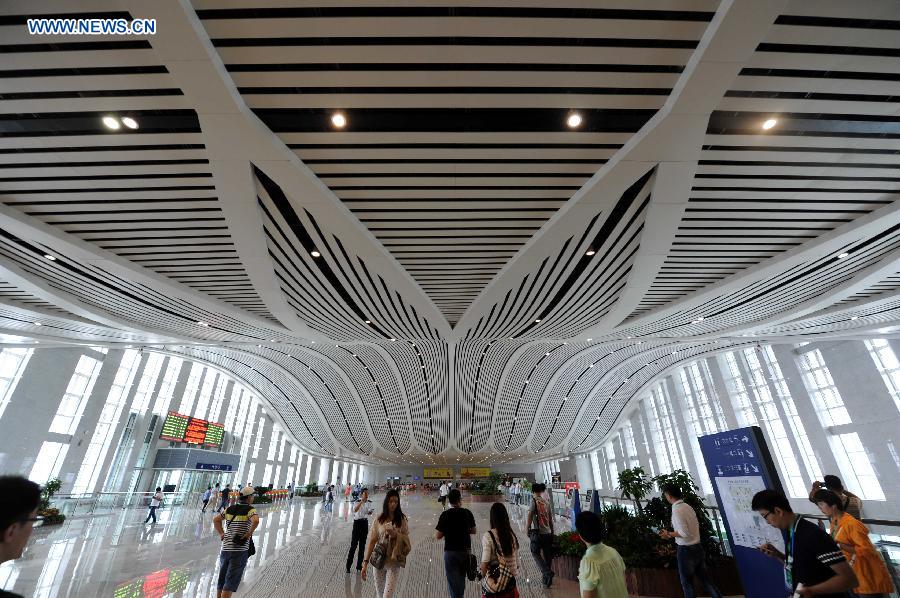 Passengers are seen at the Qiqihar South Railway Station, northeast China's Heilongjiang Province, Aug. 17, 2015.