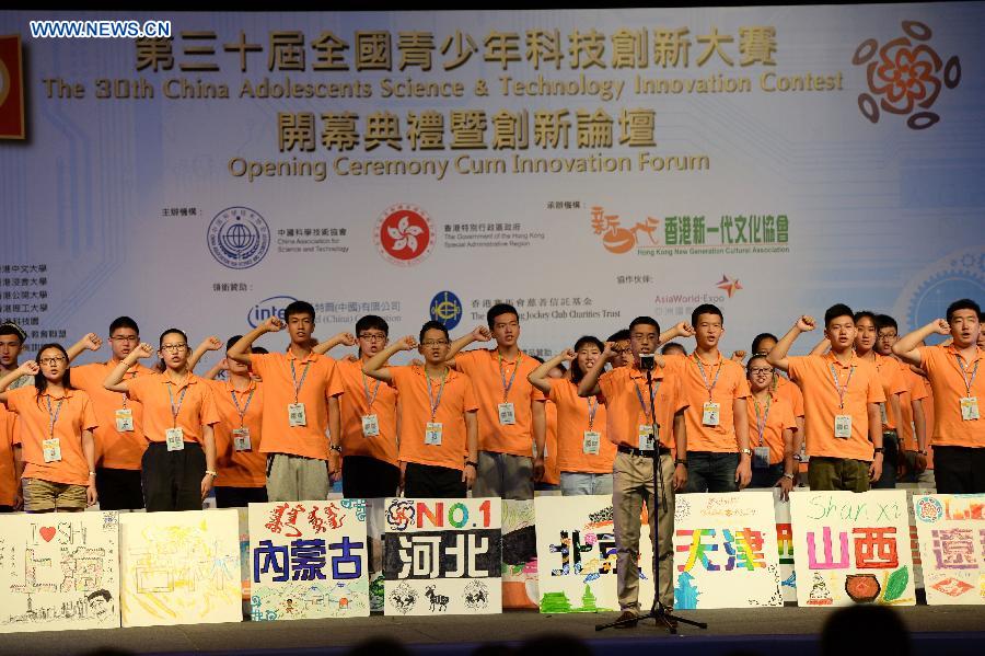 Student representatives take an oath during the opening ceremony of the 30th China Adolescents Science and Technology Innovation Contest in south China's Hong Kong, Aug. 20, 2015. 