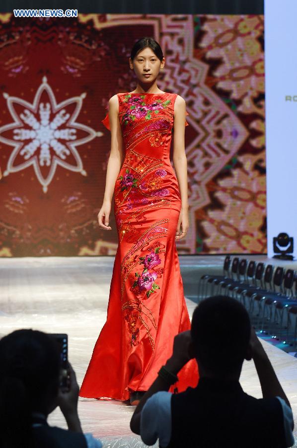 A model presents cheongsam, a traditional Chinese women's dress also known as Qipao, during a show in Kunming, southwest China's Yunnan Province, Aug. 21, 2015.