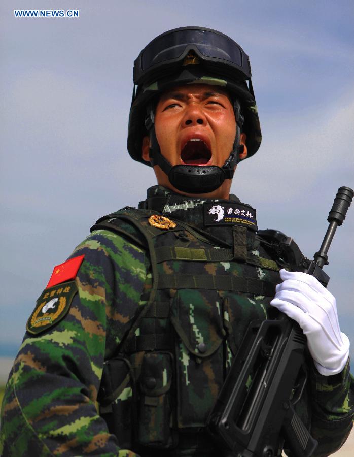 Photo taken on Aug. 14, 2015 shows a soldier participating in training for the Sept. 3 military parade at the parade training base. 