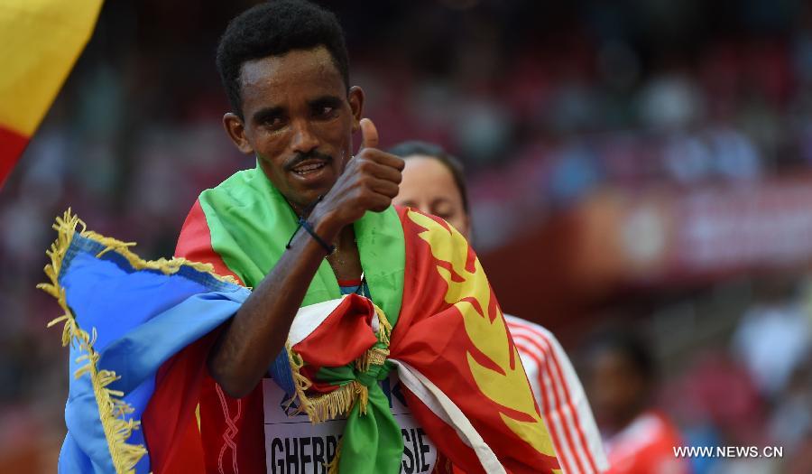 Ghirmay Ghebreslassie of Eritrea celebrates victory after the men's marathon at the 15th IAAF World Athletics Championships 2015 in Beijing, capital of China, on Aug. 22, 2015. 