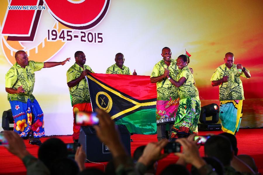 Vanuatuan officers and soldiers, who will participate in China's military parade on Sept. 3, sing a song in a party at military parade training base in Beijing, capital of China, Aug. 25, 2015.