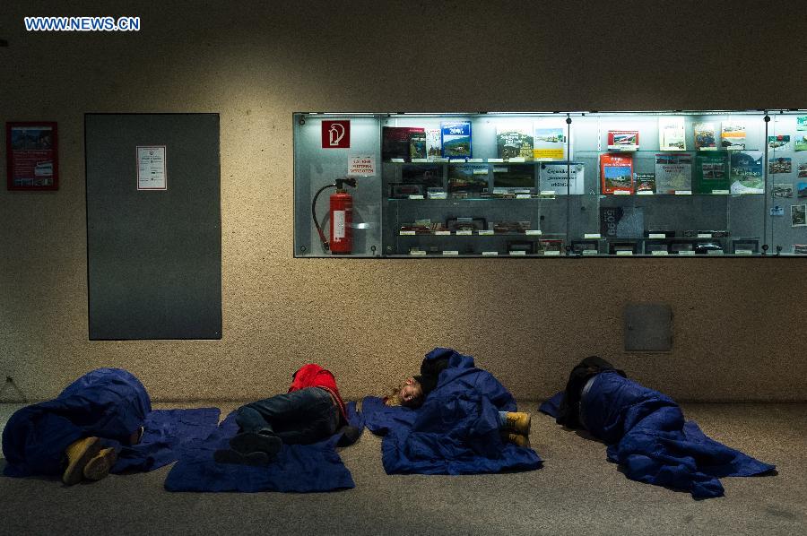 Refugees rest at a railway station in Salzburg, Austria, on Sept. 14. 2015.