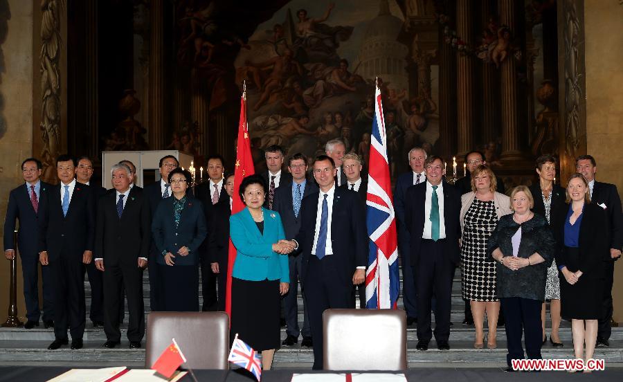 Chinese Vice Premier Liu Yandong (L Center) and British Health Secretary Jeremy Hunt (R Center) co-chair the third meeting of the China-Britain high-level cultural exchange mechanism in London, Britain, on Sept. 17, 2015. 