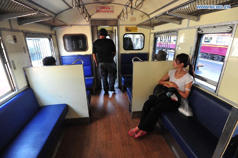 People sit in the train at Hua Lamphong Station in Bangkok, Thailand, Sept. 21, 2015. 