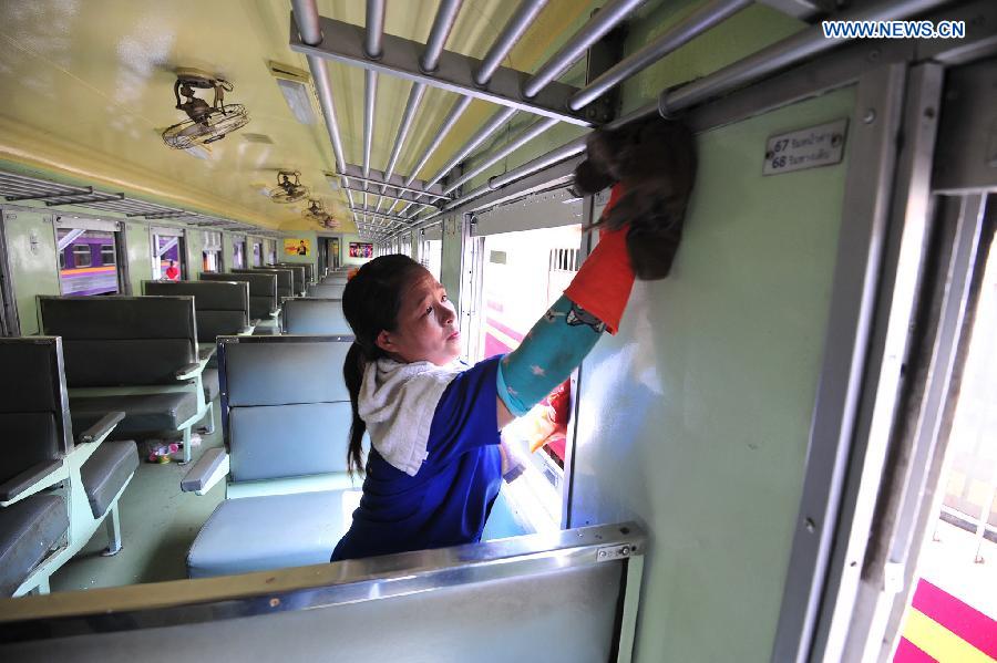 A worker cleans the train at Hua Lamphong Station in Bangkok, Thailand, Sept. 21, 2015. 