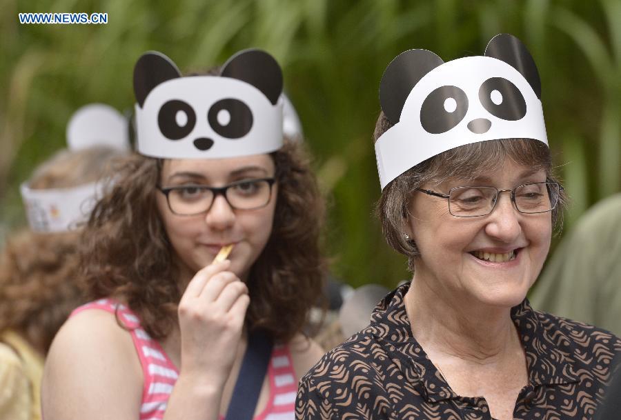 File photo taken on Aug. 23, 2014 shows people wait in line before the first birthday celebration of panda cub Bao Bao at the National Zoo, in Washington D.C., the United States. 