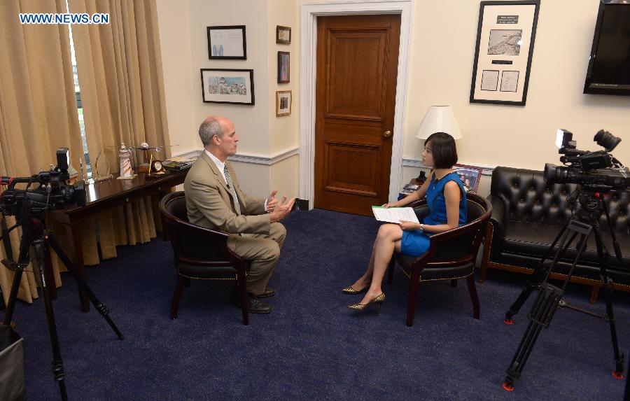 U.S. Congressman Rick Larsen (L) speaks during an interview with Xinhua News Agency on Capitol Hill in Washington, D.C., the United States, Sept. 18, 2015.