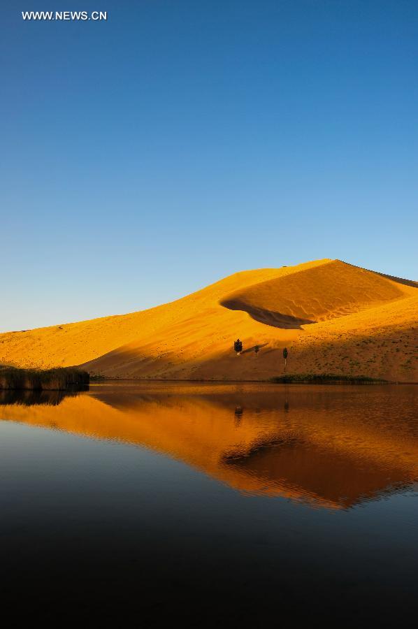 Photo taken on Sept. 22, 2015 shows the reflection of a sand dune on a lake in the Badain Jaran Desert in Araxan of north China's Inner Mongolia Autonomous Region. 