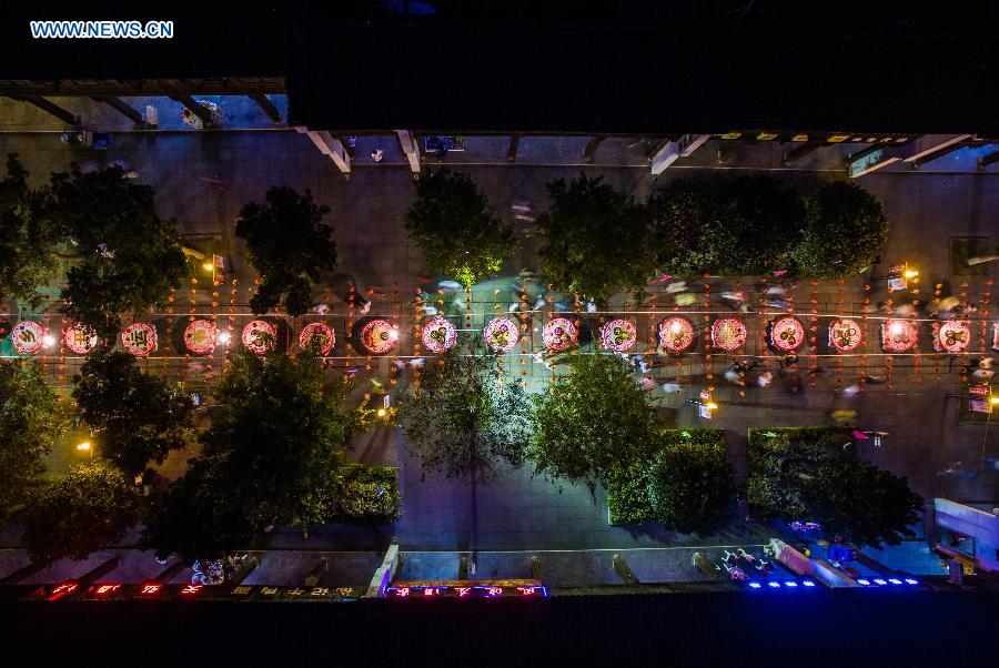 Local residents arrange a street-long banquet, presenting traditional pastries and dishes, to celebrate the coming Mid-Autumn Festival in Tangxi Town of Hangzhou, east China's Zhejiang Province, Sept. 24, 2015.