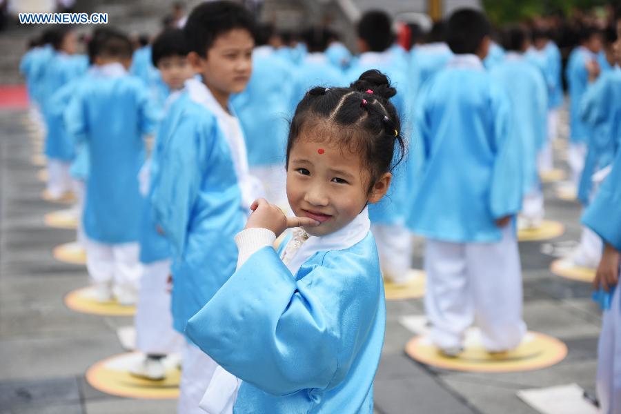 A girl is seen during a first writing ceremony in Guiyang, capital of southwest China's Guizhou Province, Sept. 28, 2015.