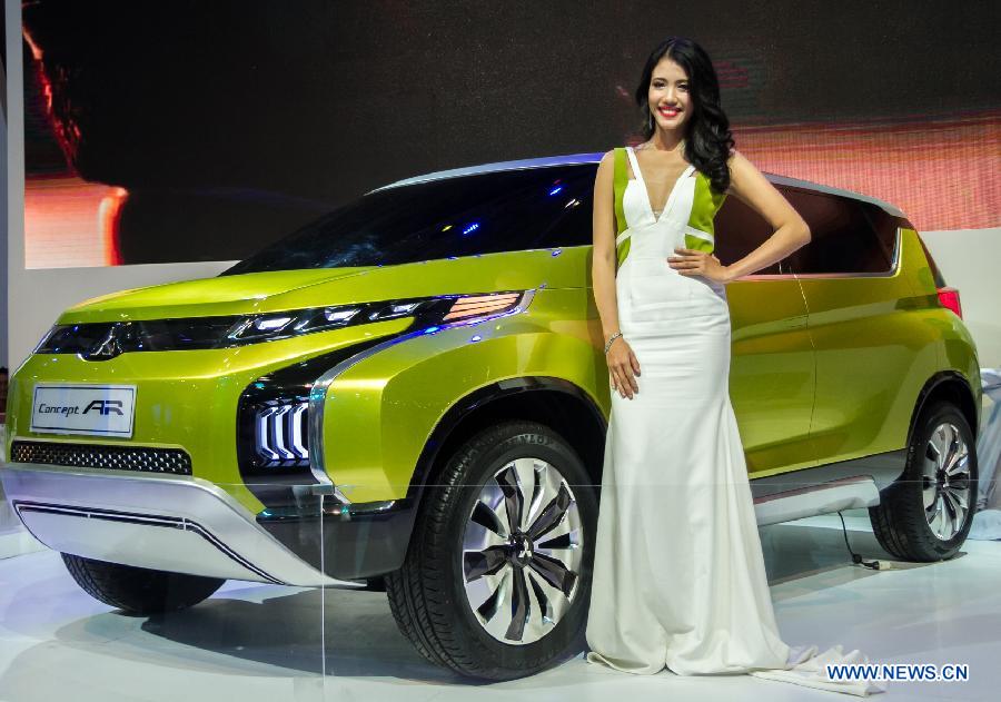 A model presents a car during the Vietnam Motor Show 2015 at Saigon Exhibition and Convention Centre in Ho Chi Minh city, Vietnam, Oct. 28, 2015.