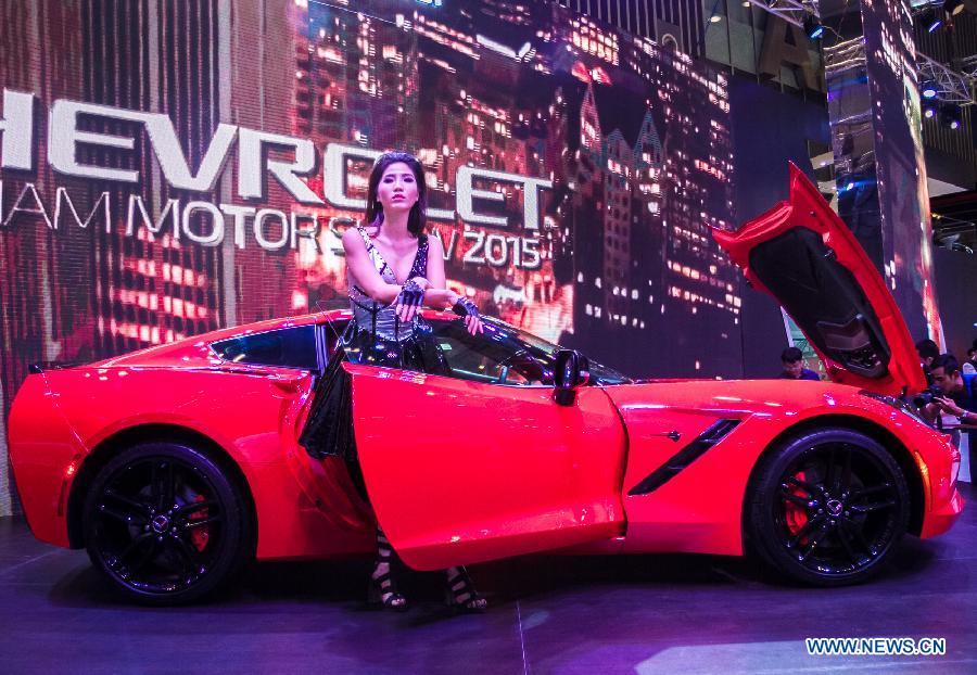 A model presents a car during the Vietnam Motor Show 2015 at Saigon Exhibition and Convention Centre in Ho Chi Minh city, Vietnam, Oct. 28, 2015.