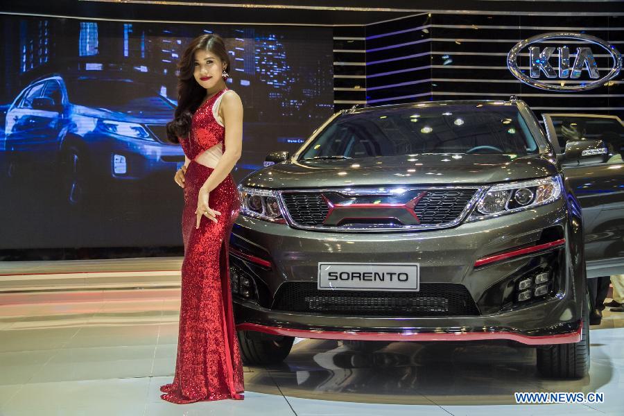 A model presents a car during the Vietnam Motor Show 2015 at Saigon Exhibition and Convention Centre in Ho Chi Minh city, Vietnam, Oct. 28, 2015.