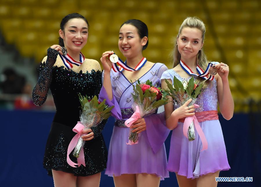 Gold medalist Mao Asada (C) of Japan, silver medalist Rika Hongo (L) of Japan and bronze medalist Elena Radionova of Russia pose during the awarding ceremony of the ladies' category at the 2015 Audi Cup ISU Grand Prix of Figure Skating in Beijing, capital of China, on Nov. 7, 2015. 