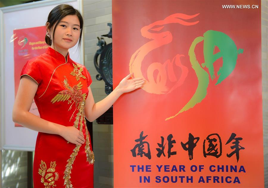 A staff member shows the newly-released logo of The Year of China in South Africa at the Chinese embassy to South Africa in Pretoria, on March 10, 2015.