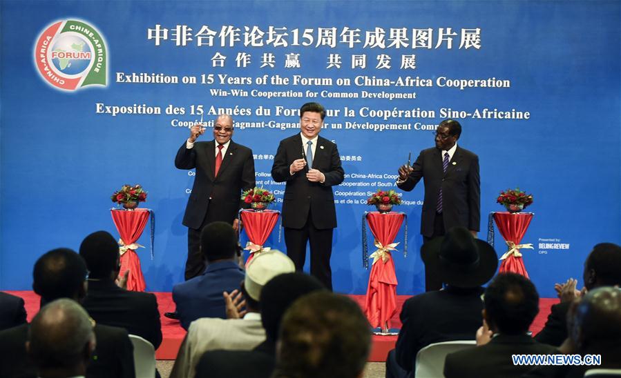 Chinese President Xi Jinping (C), South African President Jacob Zuma (L) and Zimbabwean President Robert Mugabe cut the ribbon at the opening ceremony of the Exhibition on 15 Years of the Forum on China-Africa Cooperation, in Johannesburg, South Africa, Dec. 4, 2015.