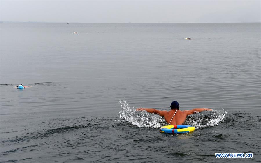 Local people swim in the Erhai Lake in Dali Bai Autonomous Prefecture southwest China's Yunnan Province, Dec. 9, 2015. 