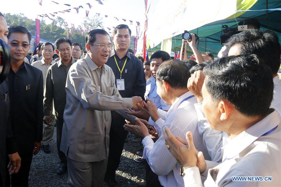 Cambodian Prime Minister Hun Sen (C) is greeted by locals during the inauguration of the 246-megawatt Tatay River Hydropower Plant in Koh Kong province, Cambodia, Dec. 23, 2015.