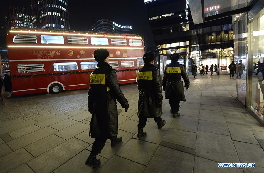 Scurity personnels patrol the popular Sanlitun area in Beijing, capital of China, Dec. 24, 2015.