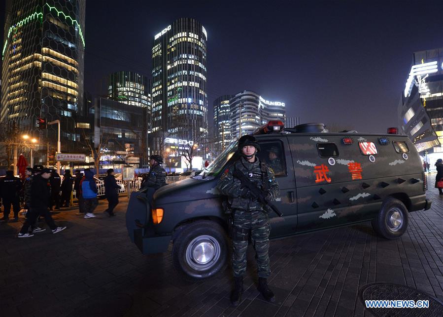 Armed police work at the popular Sanlitun area in Beijing, capital of China, Dec. 24, 2015.