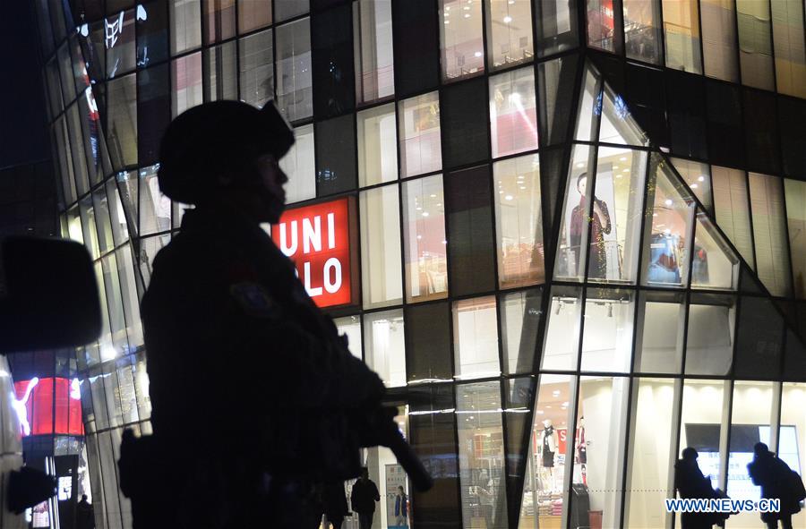 Armed police work at the popular Sanlitun area in Beijing, capital of China, Dec. 24, 2015.