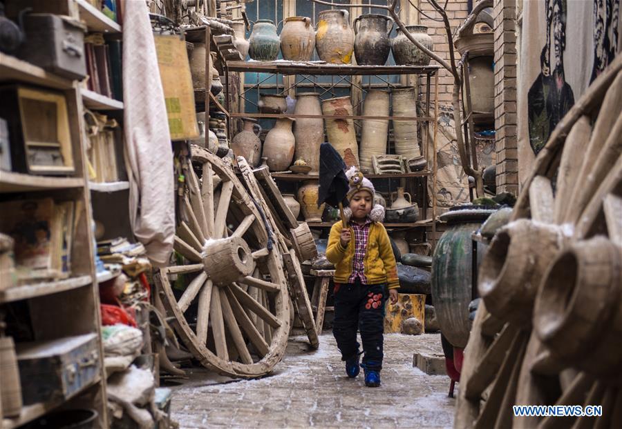 A boy plays in a yard in the old town of Kashgar, northwest China's Xinjiang Uygur Autonomous Region, Dec. 19, 2015. 