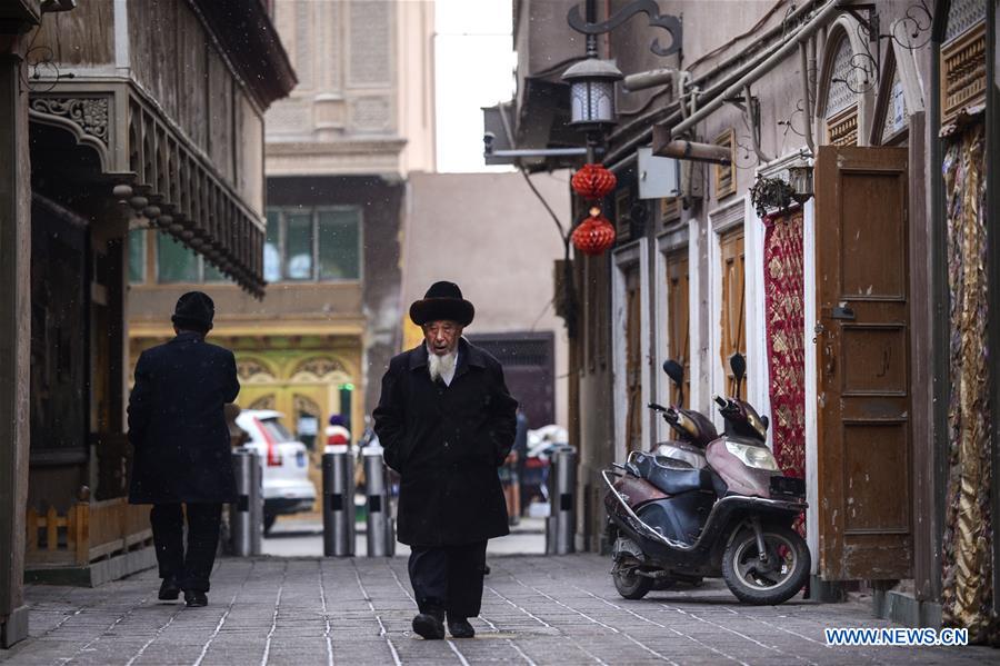 People walk on a street in the old town of Kashgar, northwest China's Xinjiang Uygur Autonomous Region, Dec. 18, 2015.