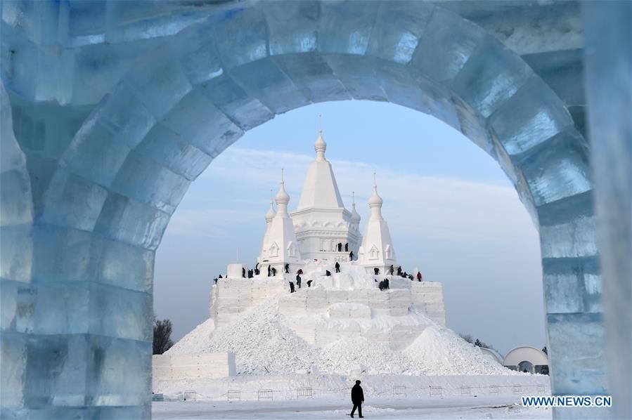 Snow sculptors work on a snow sculpture, which will be the highest in the world, in Taiyangdao, a small island in Harbin, northeast China's Heilongjiang Province, Dec. 24, 2015.