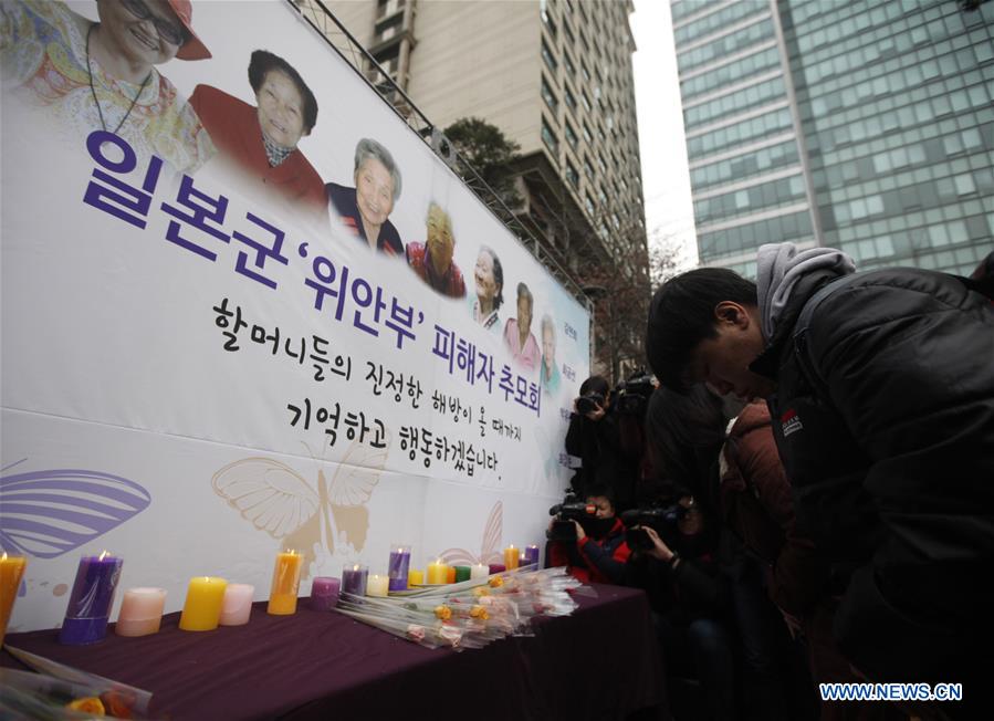People hold portraits of deceased former South Korean 'comfort women' during a weekly anti-Japan protest in front of the Japanese embassy in Seoul, South Korea, Dec. 30, 2015. 