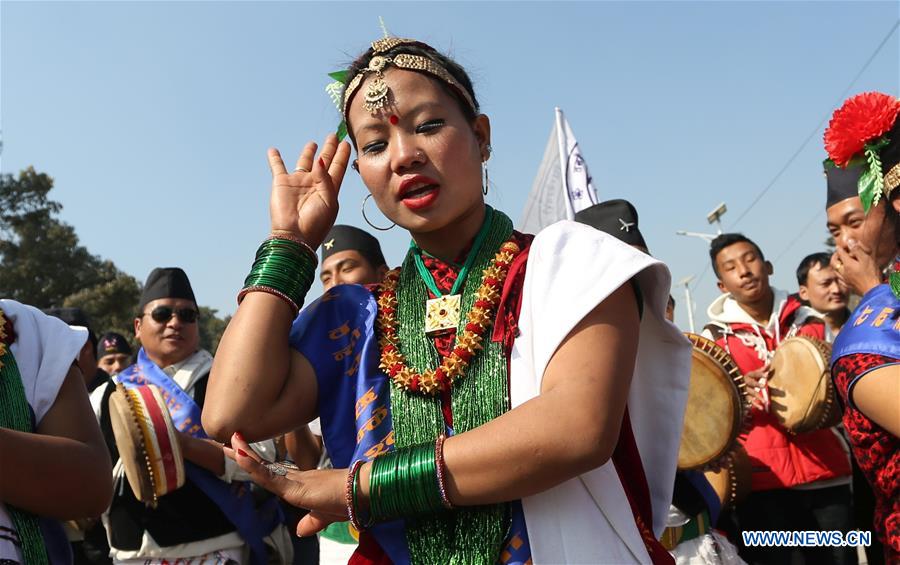 A man from ethnic Gurung community fires a bow during celebrations for the Tamu Losar (New Year) festival in Kathmandu, Nepal, Dec. 30, 2015. 