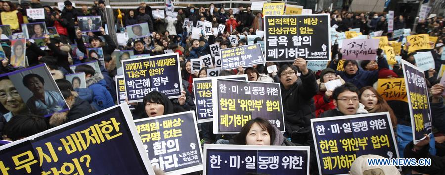 People hold portraits of deceased former South Korean 'comfort women' during a weekly anti-Japan protest in front of the Japanese embassy in Seoul, South Korea, Dec. 30, 2015. 