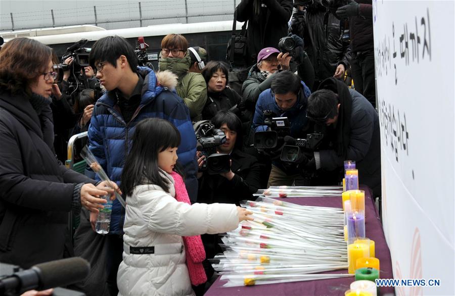 People hold portraits of deceased former South Korean 'comfort women' during a weekly anti-Japan protest in front of the Japanese embassy in Seoul, South Korea, Dec. 30, 2015. 