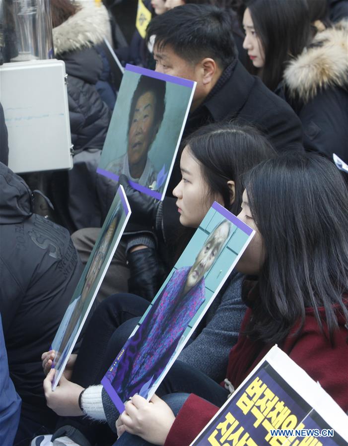 People hold portraits of deceased former South Korean 'comfort women' during a weekly anti-Japan protest in front of the Japanese embassy in Seoul, South Korea, Dec. 30, 2015. 