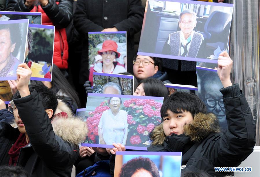 People hold portraits of deceased former South Korean 'comfort women' during a weekly anti-Japan protest in front of the Japanese embassy in Seoul, South Korea, Dec. 30, 2015. 