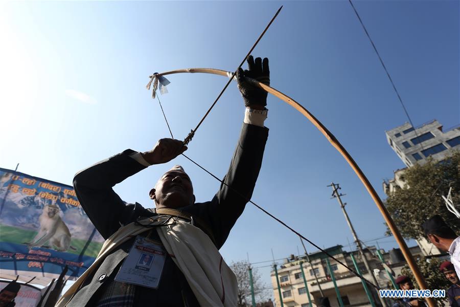 A man from ethnic Gurung community fires a bow during celebrations for the Tamu Losar (New Year) festival in Kathmandu, Nepal, Dec. 30, 2015. 