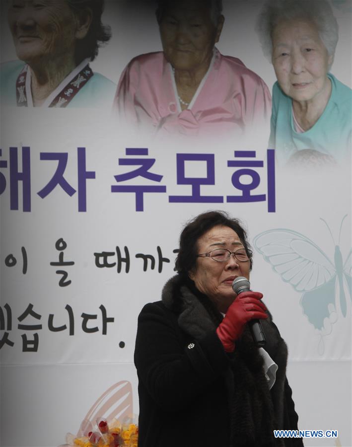 People hold portraits of deceased former South Korean 'comfort women' during a weekly anti-Japan protest in front of the Japanese embassy in Seoul, South Korea, Dec. 30, 2015. 