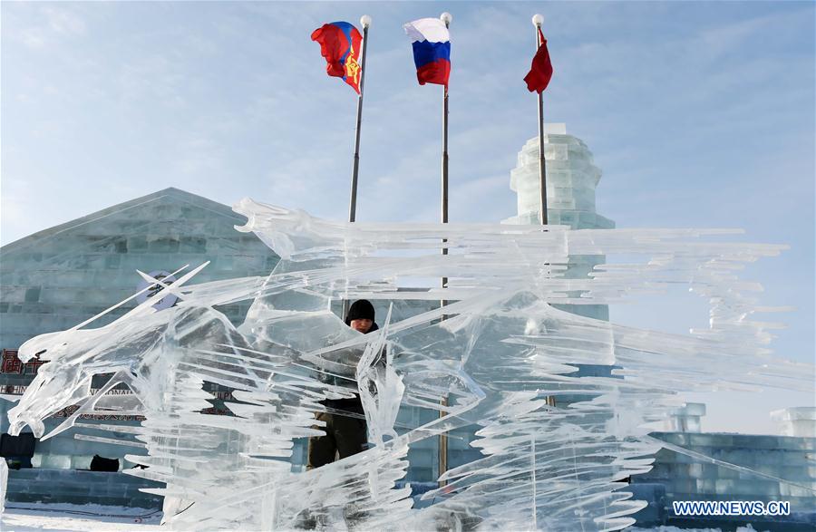 A Mongolian contestant makes ice sculpture during an international ice sculpture contest in Harbin, capital of northeast China's Heilongjiang Province, Jan. 4, 2016. 