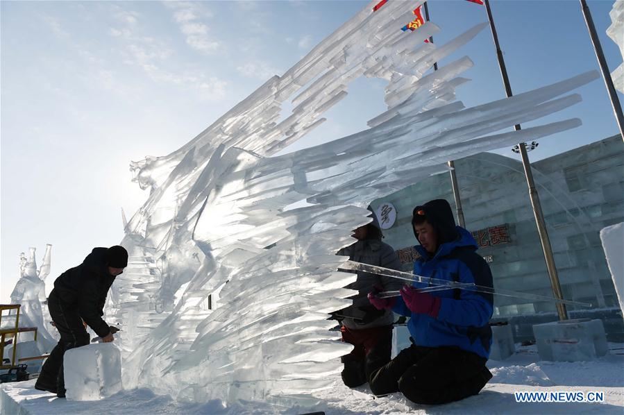 Mongolian contestants make ice sculpture during an international ice sculpture contest in Harbin, capital of northeast China's Heilongjiang Province, Jan. 4, 2016. 