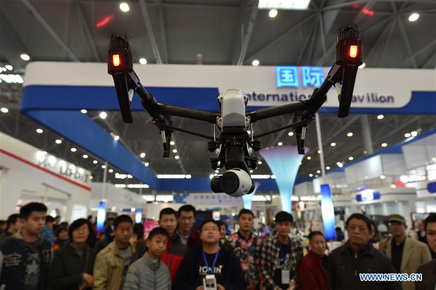  Visitors view a drone during an home appliance exhibition in Hefei, capital of east China's Anhui Province, Nov. 14, 2015. 