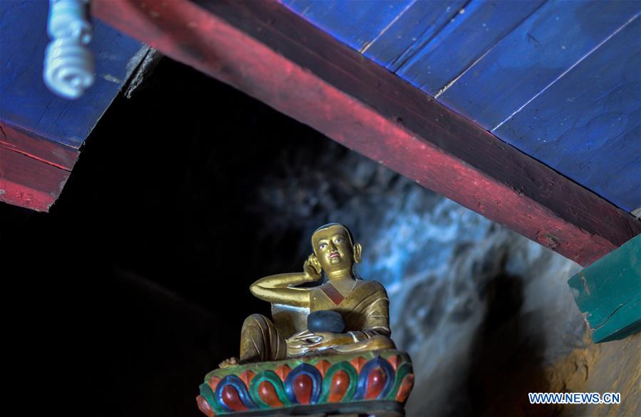 Photo taken on Jan. 4, 2016 shows a figure of Milarepa, the Kagyu master, in Cagar Monastery on the mountain in Jilung Township of Jilung County, Xigaze City, southwest China's Tibet Autonomous Region. Cagar Monastery was built in the year of 1160, and it is one of the places that Milarepa, the Kagyu master, practising Tibetan Buddhism.