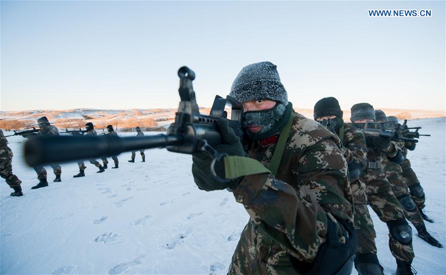 Frontier soldiers take part in a drill under cold weather in Darhan Muminggan United Banner of Baotou City, north China's Inner Mongolia Autonomous Region, Jan. 12, 2016.