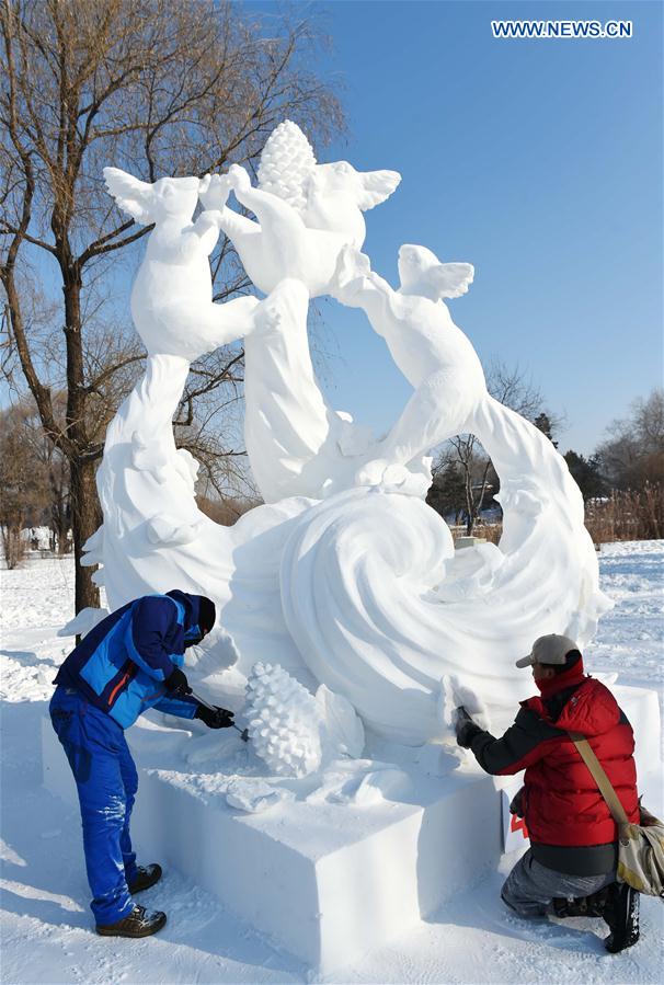 Chinese contestants make a snow sculpture in Harbin, capital of northeast China's Heilongjiang Province, Jan. 13, 2016.