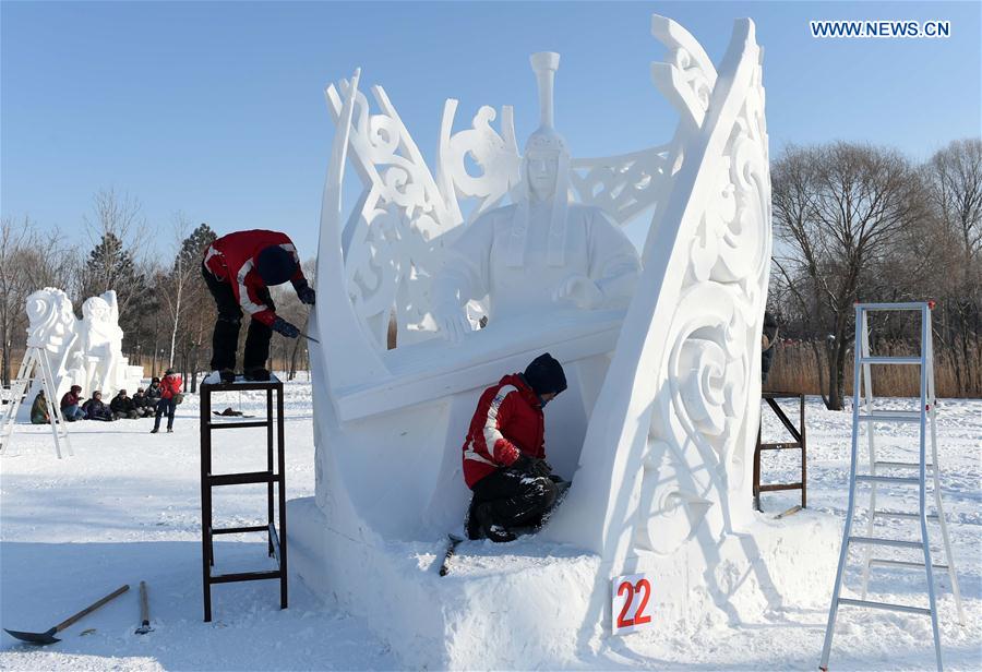 Mongolian contestants make a snow sculpture in Harbin, capital of northeast China's Heilongjiang Province, Jan. 13, 2016. 