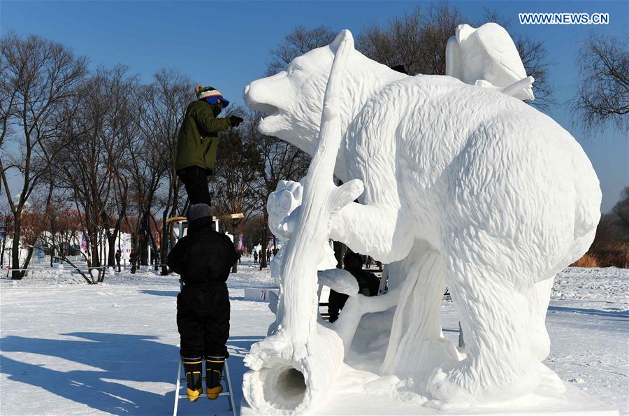 Contestants from South Korea make a snow sculpture in Harbin, capital of northeast China's Heilongjiang Province, Jan. 13, 2016. 